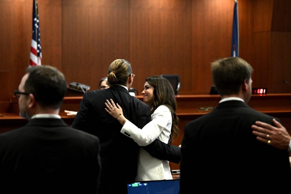 Attorney Camille Vasquez embraces US actor Johnny Depp in the courtroom at the Fairfax County Circuit Courthouse in Fairfax, Virginia, on May 17, 2022. (POOL/AFP via Getty Images)