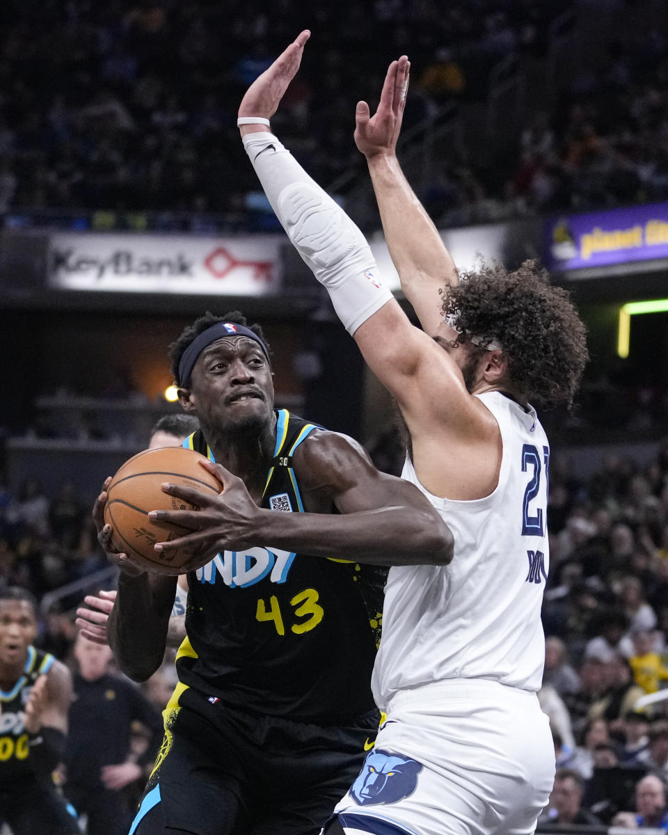 Indiana Pacers forward Pascal Siakam (43) looks to shoot around Memphis Grizzlies forward David Roddy (21) during the first half of an NBA basketball game in Indianapolis, Sunday, Jan. 28, 2024. (AP Photo/Michael Conroy)