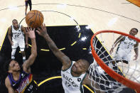 Phoenix Suns' Cameron Payne (15) shoots over Milwaukee Bucks' P.J. Tucker (17) during the first half of Game 1 of basketball's NBA Finals, Tuesday, July 6, 2021, in Phoenix. (Christian Petersen/Pool Photo via AP)