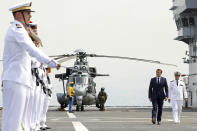 FILE - In this Sept. 1, 2020, file photo, French President Emmanuel Macron, second right, reviews the troops as he arrives on the French helicopter carrier Tonnerre, off the port of Beirut, Lebanon. During his visit last week, Macron gave Lebanon’s politicians a road map for policy changes and reform, set deadlines for them to take action and told them he’d be back in December to check on progress. It was a hands-on approach that angered some in Lebanon and was welcomed by others. (Stephane Lemouton, Pool Photo via AP, File)