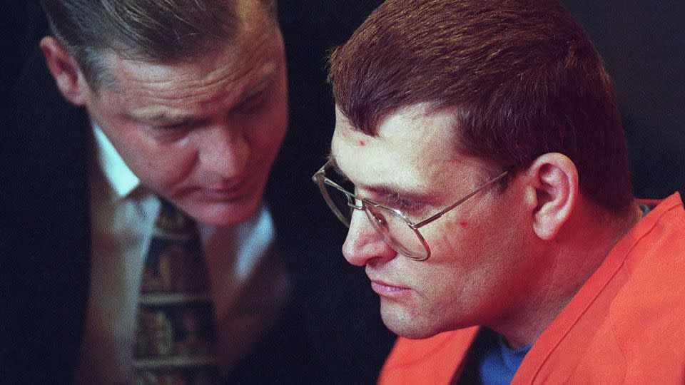 Keith Hunter Jesperson, right, listens to his attorney  moments before pleading guilty to murder charges in October 1995.  - Troy Wayrynen/The Columbian/AP