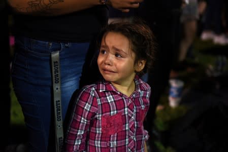 People gather for a vigil a day after a mass shooting in El Paso