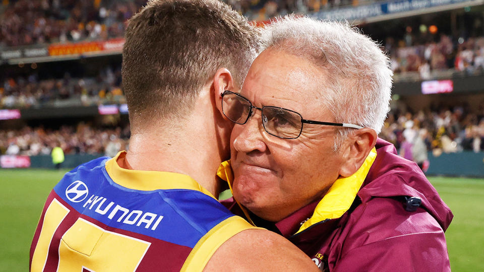 Chris Fagan embraces a Brisbane Lions player after an AFL finals victory in 2022.