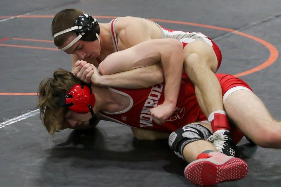 Noah Benore of Bedford works on Monroe's Tommy Honeycutt in the Southeastern Conference finals at 130 pounds Saturday. Benore won 6-1.