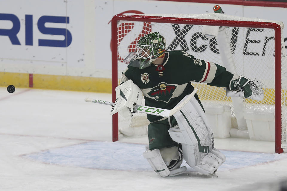 Minnesota Wild's goalie Kaapo Kahkonen watches the puck after he blocked a goal-attempt by the San Jose Sharks in the first period of an NHL hockey game Sunday, Jan. 24, 2021, in St. Paul, Minn. (AP Photo/Stacy Bengs)