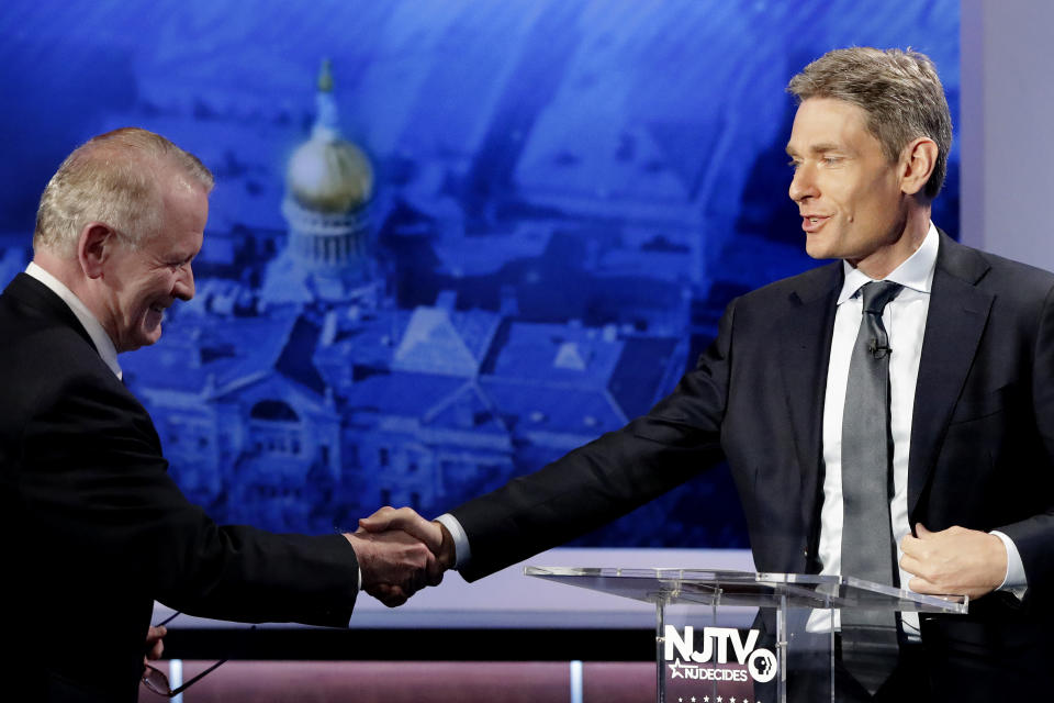 Republican candidate Leonard Lance, left, shakes hands with Democratic candidate Tom Malinowski prior to a U.S. Congressional District 7 debate, Wednesday, Oct. 17, 2018, in Newark, N.J. (AP Photo/Julio Cortez)