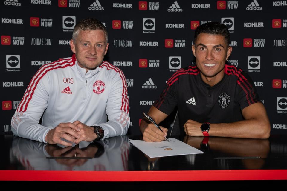 Cristiano Ronaldo of Manchester United poses with Manager Ole Gunnar Solskjaer after signing his contract with the club at Carrington Training Ground (Manchester United via Getty Images)