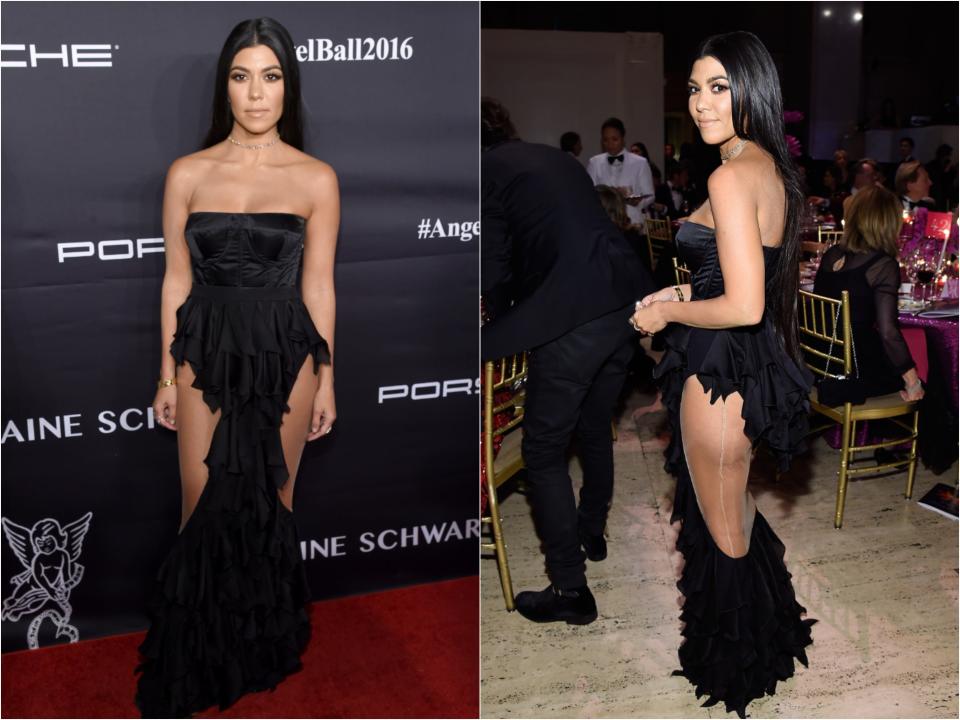 Kourtney in a black strapless gown with ruffles and large cutouts along her thighs with mesh paneling.