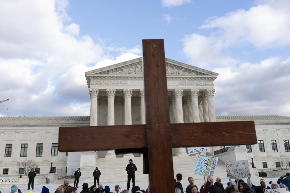 FILE - Anti-abortion activists hold a cross as they rally outside of the U.S. Supreme Court during the March for Life in Washington, Friday, Jan. 20, 2023. (AP Photo/Jose Luis Magana, File)