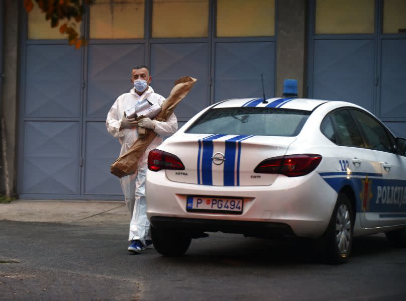 A police investigator holds evidence material on the site of the attack in Cetinje, August 2022