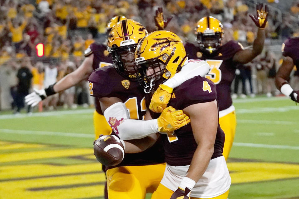 Arizona State running back Cameron Skattebo (4) celebrates his touchdown against Southern Utah with tight end Jalin Conyers during the first half of an NCAA college football game Thursday, Aug. 31, 2023, in Tempe, Ariz. (AP Photo/Ross D. Franklin)