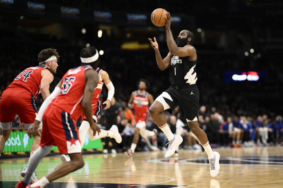 Los Angeles Clippers guard James Harden (1) passes the ball against Washington Wizards forward Corey Kispert (24) and guard Delon Wright (55) during the first half of an NBA basketball game, Wednesday, Jan. 31, 2024, in Washington. (AP Photo/Nick Wass)