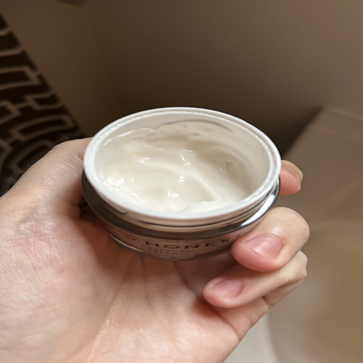 A hand holding cream