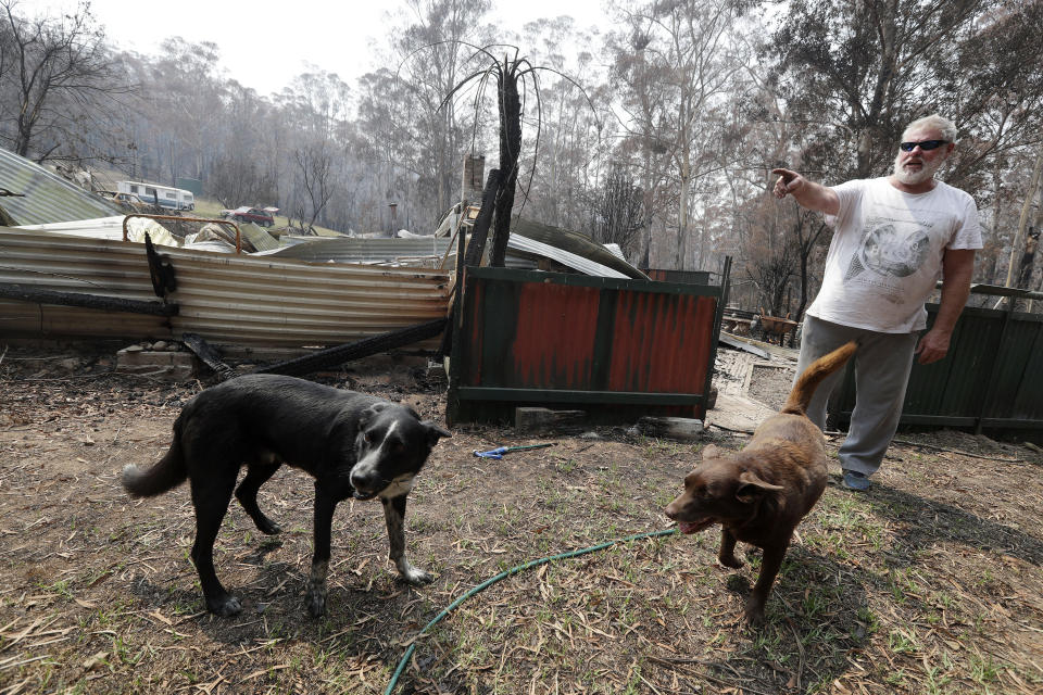 Lyle Stewart stands in front of his destroyed home at Nerrigundah, Australia, Monday, Jan. 13, 2020, after a wildfire ripped through the town on New Year's Eve. The tiny village of Nerrigundah in New South Wales has been among the hardest hit by Australia's devastating wildfires, with about two thirds of the homes destroyed and a 71-year-old man killed. (AP Photo/Rick Rycroft)