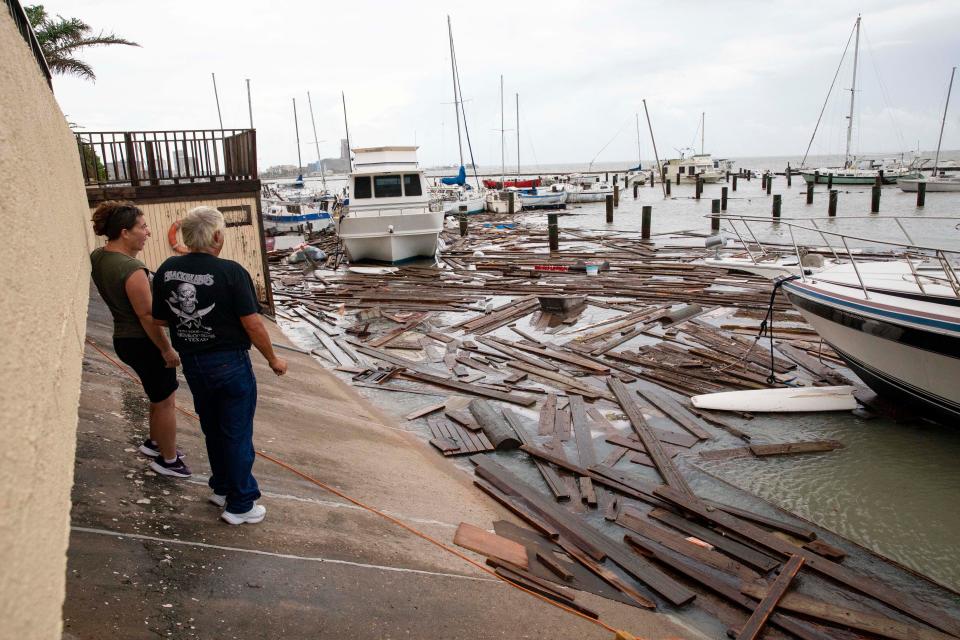 Boat owners survey the damage at Harbor Del Sol Marina as they check their boats the morning after Hurricane Hanna on July 26 in Corpus Christi, Texas.