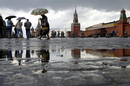 People walk in Red Square during a rainy day in Moscow, Russia, June 30, 2008. REUTERS/Denis Sinyakov/File Photo