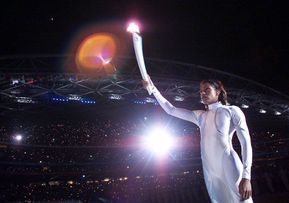 Australia's Cathy Freeman, world record holder of the women's 400m race, holds the torch before lighting up the Olympic Flame at the Olympic Stadium during the Opening Ceremony of the XXVII Olympic Games, September 15, 2000. Athletes from 199 nations are participating in the Games which will continue until October 1.

KPFF/HB