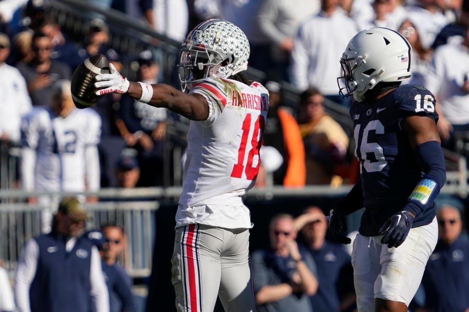 Oct 29, 2022; University Park, Pennsylvania, USA; Ohio State Buckeyes wide receiver Marvin Harrison Jr. (18) celebrates a first down catch beside Penn State Nittany Lions safety Ji'Ayir Brown (16) during the fourth quarter of the NCAA Division I football game at Beaver Stadium. Mandatory Credit: Adam Cairns-The Columbus Dispatch