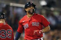 Boston Red Sox's Xander Bogaerts celebrates after scoring on a single by J.D. Martinez during the ninth inning of a baseball game against the New York Yankees, Friday, Aug. 12, 2022, in Boston. (AP Photo/Michael Dwyer)