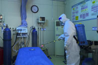 A hospital worker in protective gear disinfects the ward of an emergency department of Baigou New Area Aerospace Hospital in Baigou in northern China's Hebei province on Thursday, Dec. 22, 2022. As China grapples with its first-ever wave of COVID mass infections, emergency wards in the towns and cities to Beijing's southwest are overwhelmed. Intensive care units are turning away ambulances, residents are driving sick relatives from hospital to hospital, and patients are lying on floors for a lack of space. (AP Photo)