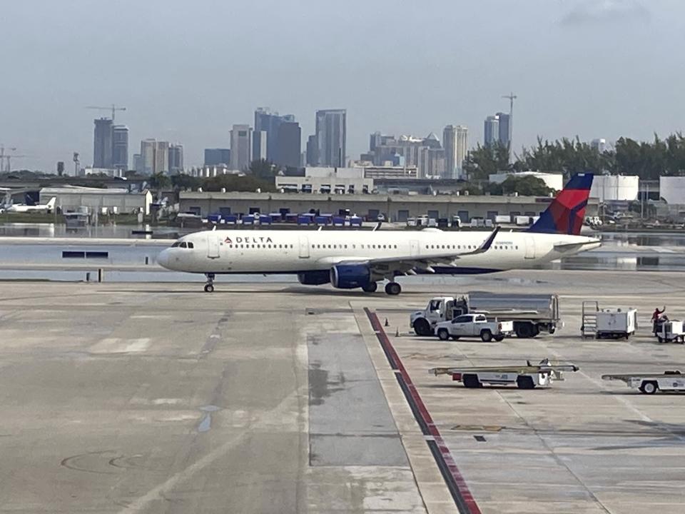 A Delta Airlines plane departs from Terminal 2 as normal operations resume at Fort Lauderdale-Hollywood International Airport on Friday, April 14, 2023. The airport was closed late Wednesday after torrential rains caused major flooding across South Florida. (Mike Stocker/South Florida Sun-Sentinel via AP)