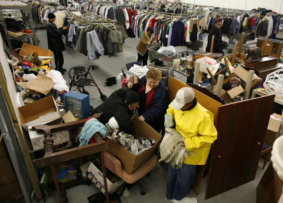 People look for clothes at the Capuchin Soup Kitchen service center, where hundreds of people receive food and supplies everyday, in Detroit, Michigan, December 9, 2008. REUTERS/Carlos Barria