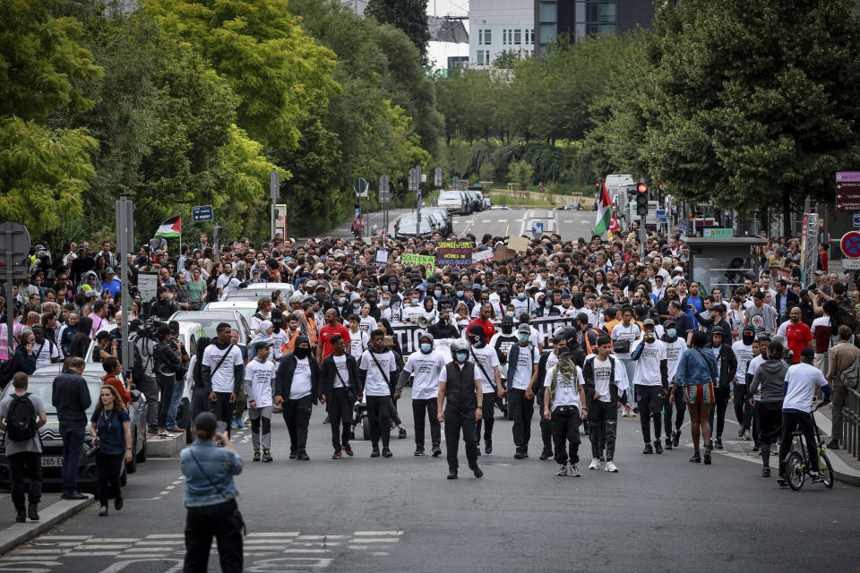 Protestors attend a silent march called by the mother of 17-year-old Nahel Merzouk who was killed by police to mark one year since his death, in Nanterre, west of Paris, Saturday, June 29, 2024. The murder of 17-year-old Nahel by an on-duty police officer in June 2023 sparked riots across France. (AP Photo/Aurelien Morissard)