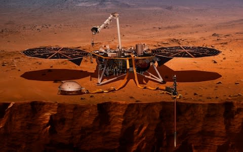 This illustration shows the InSight lander drilling into the surface of Mars - Credit: NASA