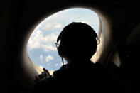 U.S. Navy LT JG Katia Medford-Davis looks from a window of a U.S. Navy Lockheed P-3C Orion patrol aircraft from Sigonella, Sicily, Sunday, May 22, 2016, searching the area in the Mediterranean Sea where the Egyptair flight 804 en route from Paris to Cairo went missing on May 19. (AP Photo/Salvatore Cavalli)