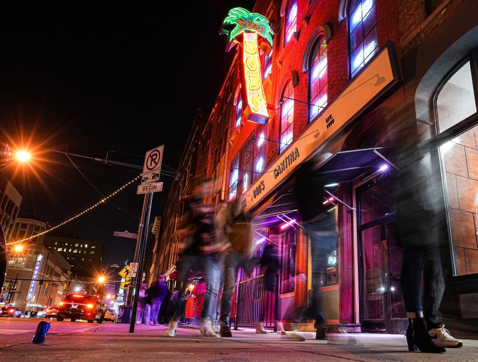 Bar goers walk down the sidewalk Saturday, Jan. 14, 2023 on South Meridian Street in downtown Indianapolis. 