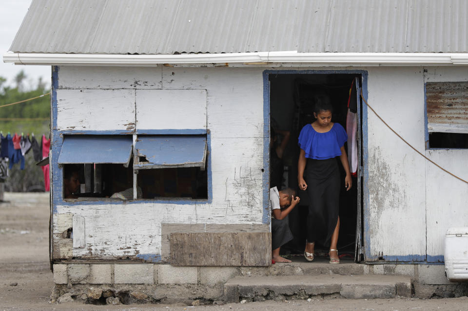 In this Sunday, April 7, 2019, photo, locals prepare to leave their house in Nuku'alofa, Tonga. China is pouring billions of dollars in aid and low-interest loans into the South Pacific, and even in the far-flung kingdom of Tonga there are signs that a battle for power and influence among much larger nations is heating up and could exact a toll. (AP Photo/Mark Baker)