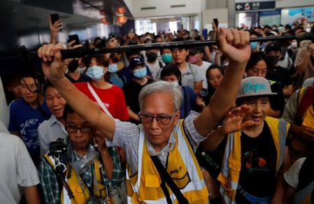 A man tries to block riot police during a protest in Tung Chung station, in Hong Kong