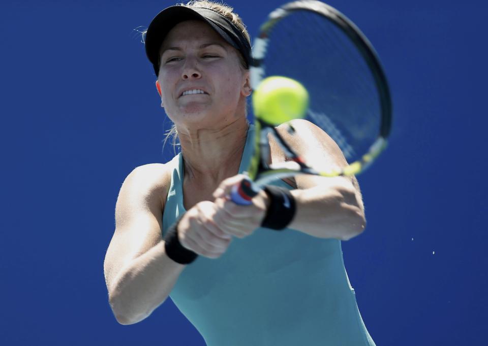 Eugenie Bouchard of Canada hits a return to Tang Haochen of China during their women's singles match at the Australian Open 2014 tennis tournament in Melbourne January 13, 2014. REUTERS/Brandon Malone (AUSTRALIA - Tags: SPORT TENNIS)