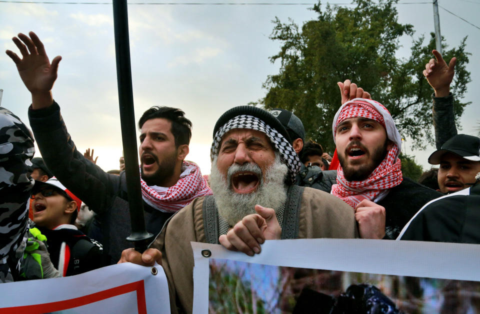 FILE - Family members and friends of a protester who was killed during clashes with security forces chant slogans against the Iraqi government during his symbolic funeral in Baghdad, Iraq, Jan. 21, 2020. According to a study released Thursday, April 11, 2024, voters in 19 countries, including in three of the world’s largest democracies, are widely skeptical about whether their elections are free and fair, and many favor a strong, undemocratic leader. (AP Photo/Hadi Mizban, File)