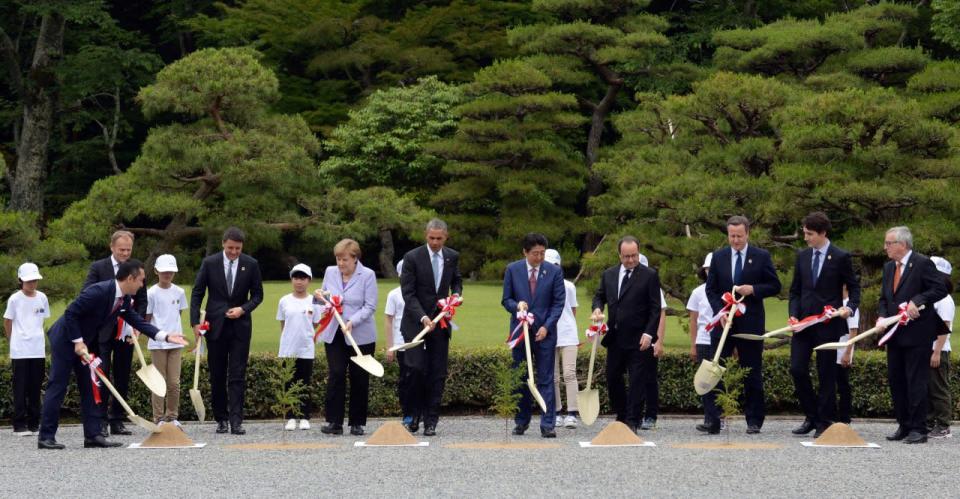 Mie Prefecture Gov. Eikei Suzuki, left, leads leaders of Group of Seven industrial nations, from second left, European Council President Donald Tusk, Italian Prime Minister Matteo Renzi, German Chancellor Angela Merkel, U.S. President Barack Obama, Japanese Prime Minister Shinzo Abe, French President Francois Hollande, British Prime Minister David Cameron, Canadian Prime Minister Justin Trudeau and European Commission President Jean-Claude Juncker, participating a tree planting ceremony as children watch them during a visit to the Ise Jingu shrine in Ise, Mie Prefecture, Japan, Thursday, May 26, 2016, as part of the G-7 Summit. (Ma Ping/Pool Photo via AP)