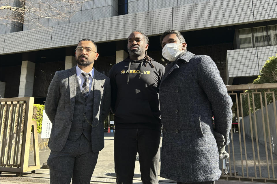 Syed Zain, left, and other plaintiffs of a lawsuit filed in Tokyo District Court stand together in front of the Tokyo District Courthouse in Tokyo Monday, Jan. 29, 2024. A civil lawsuit filed Monday in the Japanese court is demanding an end to what it calls racial profiling by police. (AP Photo/Ayaka McGill)