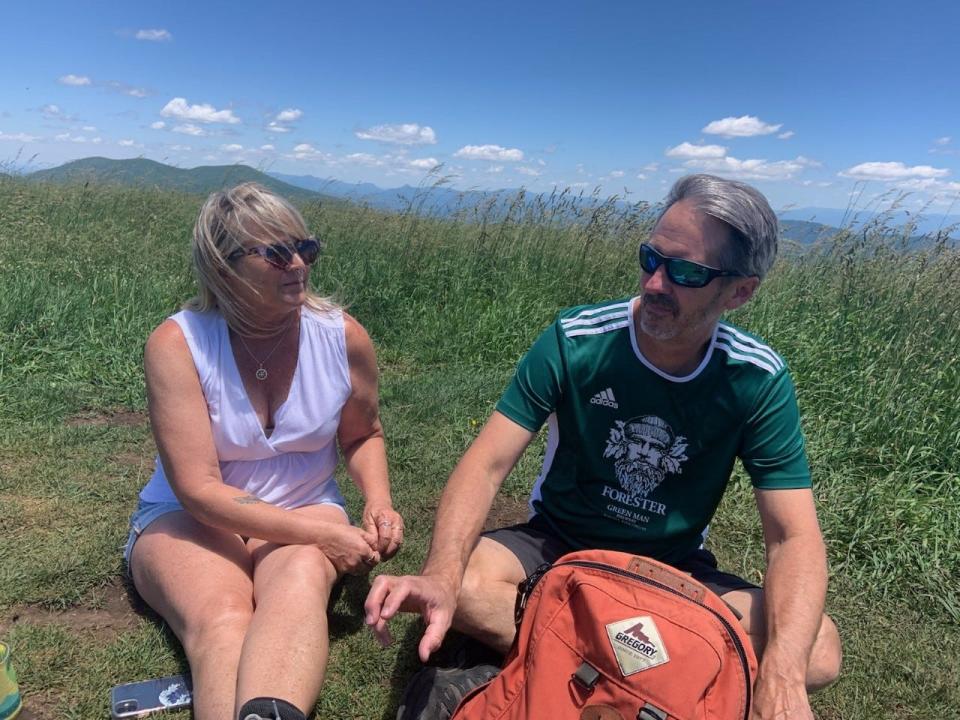 Diane Morgan, of Florida, and Amos Ivey, of Glen Alpine, N.C., enjoy a picnic atop Max Patch on June 18, 2022.