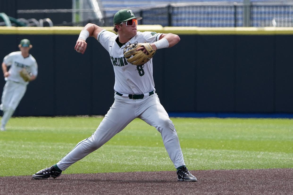 Trinity's Jake Schweitzer throws to first base during the state semifinals against Pleasure Ridge Park.