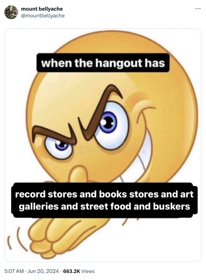 An emoji with a conniving expression, captioned "when the hangout has record stores and book stores and art galleries and street food and buskers."