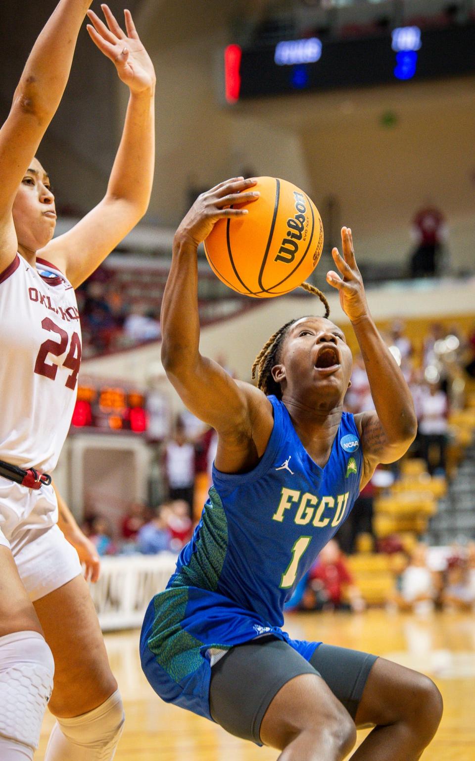 Florida Gulf Coast's Emani Jefferson (1) ball fakes Oklahoma's Skylar Vann (24) during first round NCAA action at Simon Skjodt Assembly Hall on Saturday, March 23, 2204.