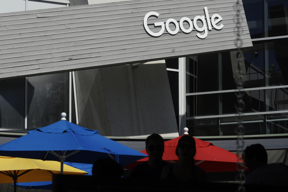 CORRECTS TO A GROUP OF 35 STATES AS WELL AS THE DISTRICT OF COLUMBIA AND TERRITORIES OF GUAM AND PUERTO RICO FILED, INSTEAD OF 38 STATES FILE - In this Sept. 24, 2019, file photo people walk by a Google sign on the company's campus in Mountain View, Calif. A group of 35 states as well as the District of Columbia and the territories of Guam and Puerto Rico filed an anti-trust lawsuit against Google on Thursday, Dec. 17, 2020, alleging that the search giant has an illegal monopoly over the online search market that hurts consumers and advertisers. The lawsuit, announced by Colorado Attorney General Phil Weiser, was filed in federal court in Washington, D.C. by states represented by bipartisan attorneys general. (AP Photo/Jeff Chiu, File)