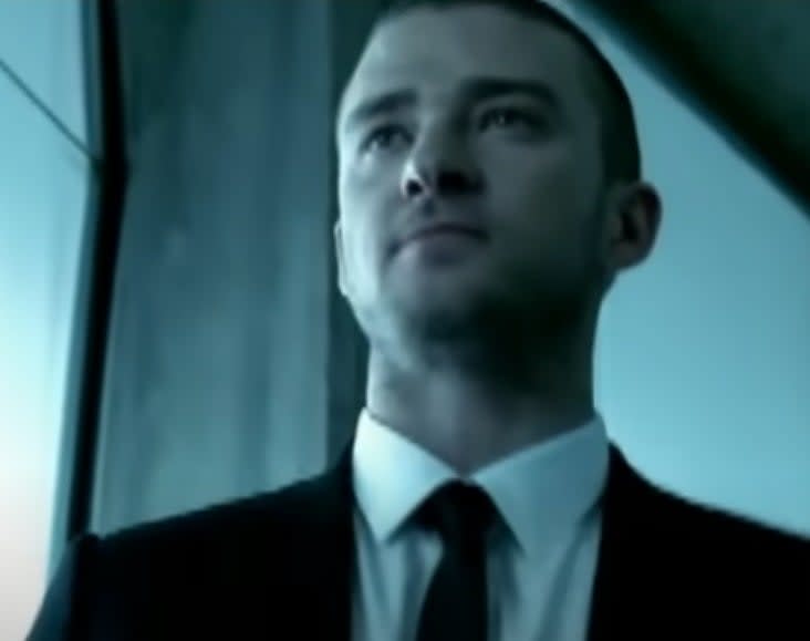 Justin Timberlake walks down a hallway as he sings "SexyBack"