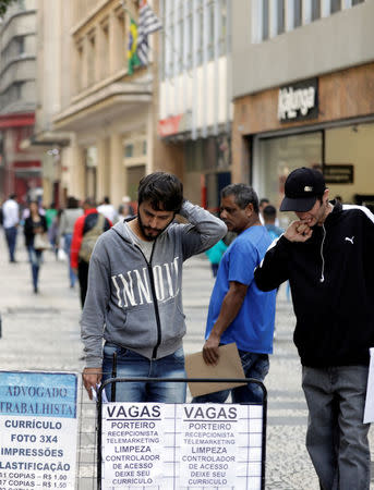 People look at lists of job openings posted on a street in downtown Sao Paulo, Brazil June 29, 2017. Picture taken June 29, 2017. REUTERS/Paulo Whitaker