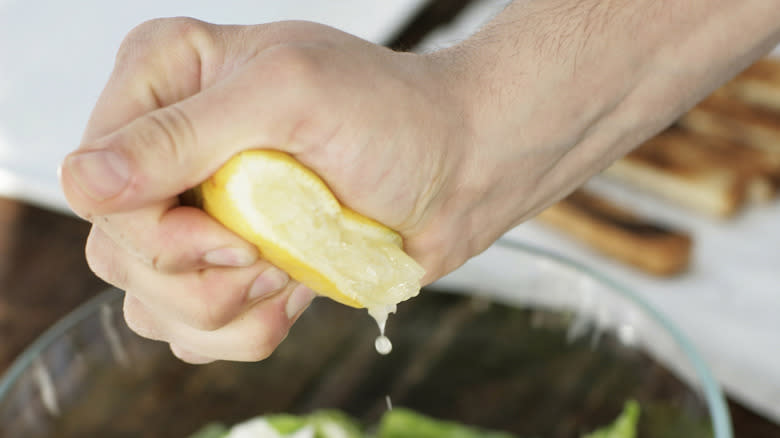 Squeezing lemon juice on salad