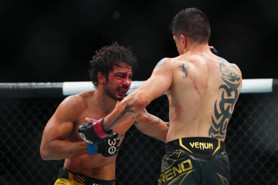 Jul 8, 2023; Las Vegas, Nevada, USA; Brandon Moreno (red gloves) fights Alexandre Pantoja (blue gloves) during UFC 290 at T-Mobile Arena. Mandatory Credit: Stephen R. Sylvanie-USA TODAY Sports