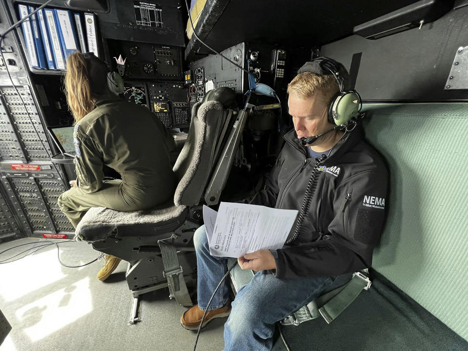 New Zealand's Prime Minister Chris Hipkins sit in a military plane Saturday, Jan. 28, 2023 bound for Auckland to assess the rain and flooding damage. Torrential rain and flooding continued to cause widespread disruption to New Zealand's largest city. (Ryan Benton/Pool Photo via AP)