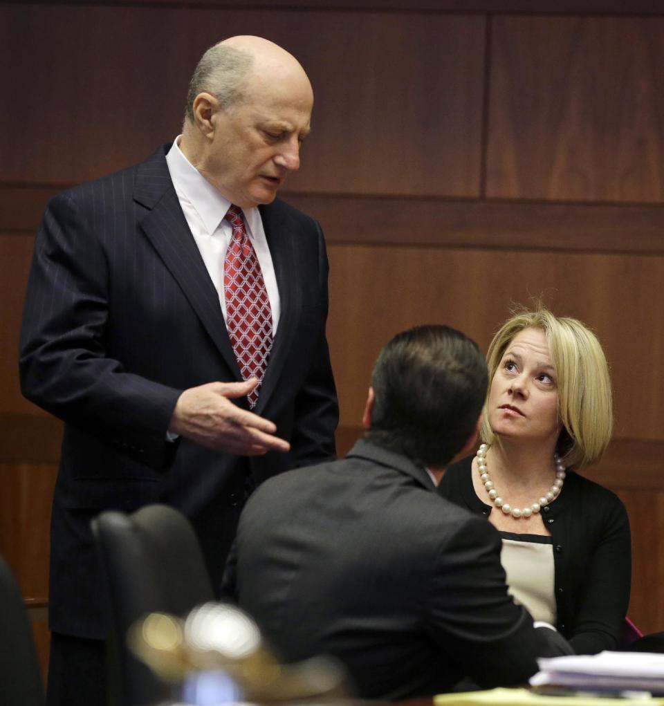 New Jersey Gov. Chris Christie's former Deputy Chief of Staff Bridget Anne Kelly, right, listens to her attorney Michael Critchley, left, as they wait in court for a hearing Tuesday, March 11, 2014, in Trenton, N.J. Attorneys for Kelly and two-time campaign manager Bill Stepien are in court to try to persuade a judge not to force them to turn over text messages and other private communications to New Jersey legislators investigating the political payback scandal ensnaring Christie's administration. (AP Photo/Mel Evans, Pool)