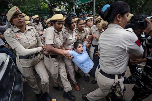 PHOTO: Sakshi Malik, in blue, an Indian wrestler who won a bronze medal at the 2016 Summer Olympics, is detained by the police during a protest demonstration at Jantar Mantar, an area near the Indian parliament, in New Delhi, May, 28, 2023. (Altaf Qadri/AP)