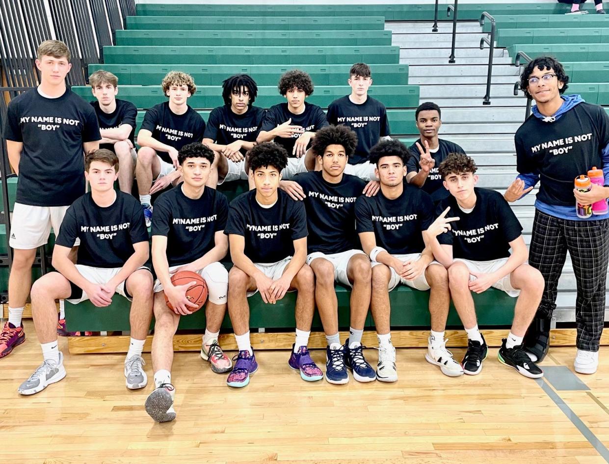 Members of the Greenfield High School boys basketball team wear shirts saying "My Name is Not Boy" in support of Omar Surveyor (first row, third from left), who said the school's athletic director, Trent Lower, called him a racial slur.