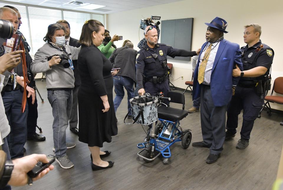 Community activist Ben Frazier is handcuffed by a member of the Jacksonville Sheriff's Office after refusing to leave the room where a news conference with Gov. Ron DeSantis was to be held. It was relocated from the Department of Children and Families office building to the adjacent FDLE building after the Jan. 4 protest.